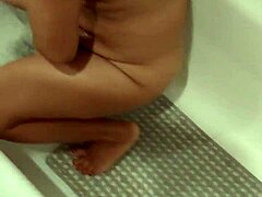 Horny mommy takes a bath and shows off her hairy pussy
